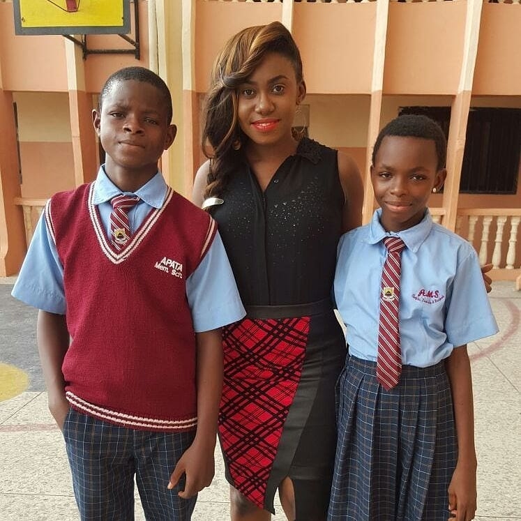 Niniola Apata with young school boy and school girl - Adopt a child's education